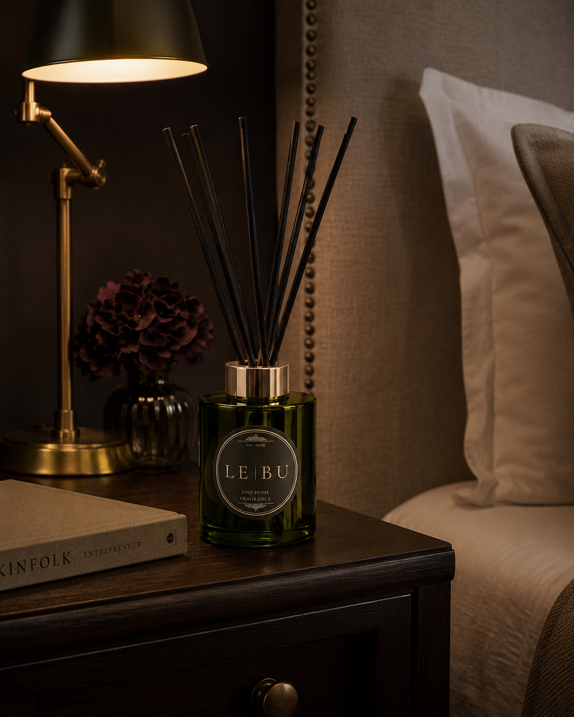 LE BU green glass reed diffuser styled on a marble console with candlelight and luxury home decor