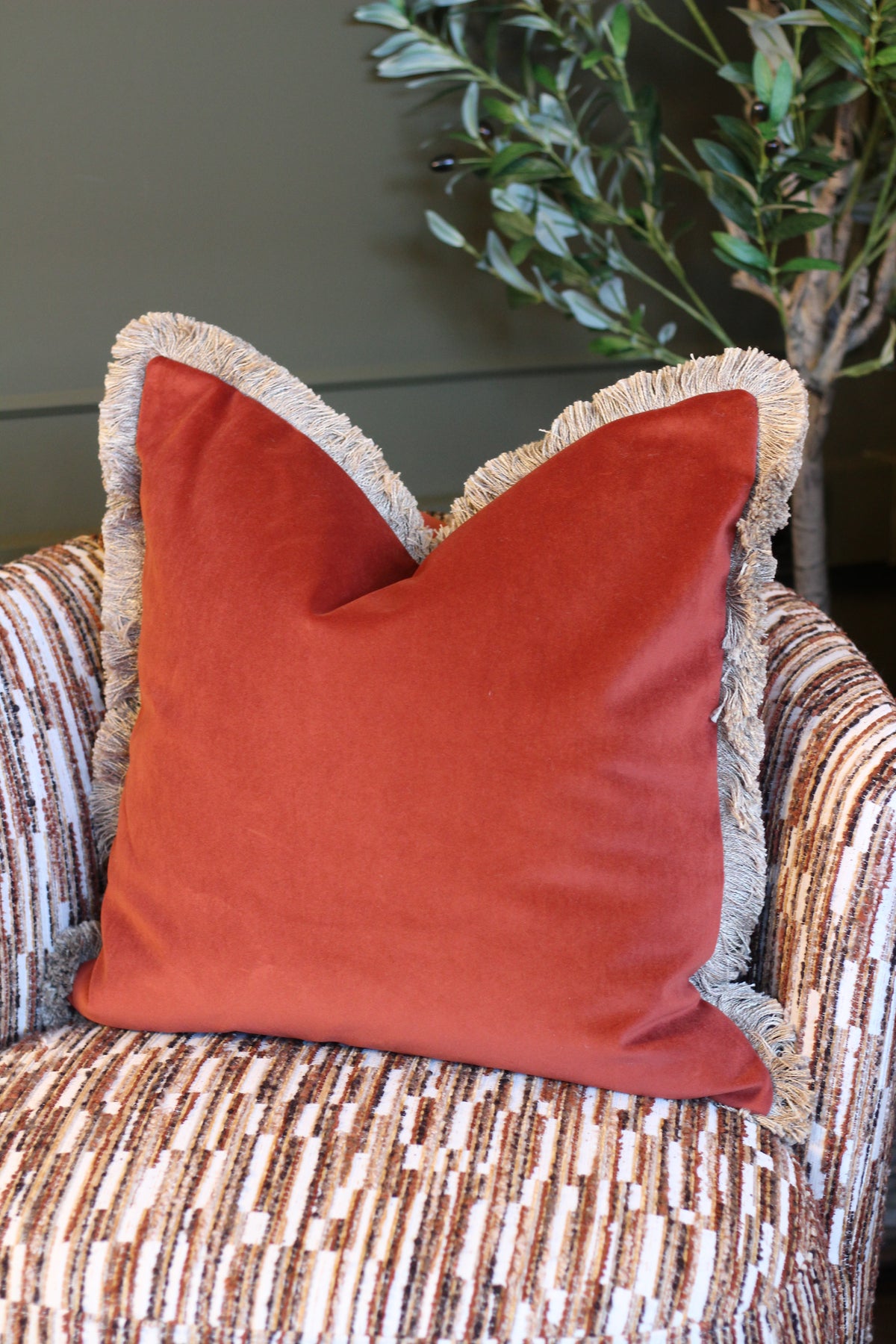 Langford Rust fringed velvet cushion in a warm rust tone, 55 x 55cm