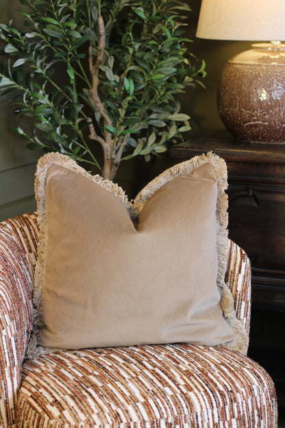 Langford Stone fringed velvet cushion in a warm neutral tone, 55 x 55cm