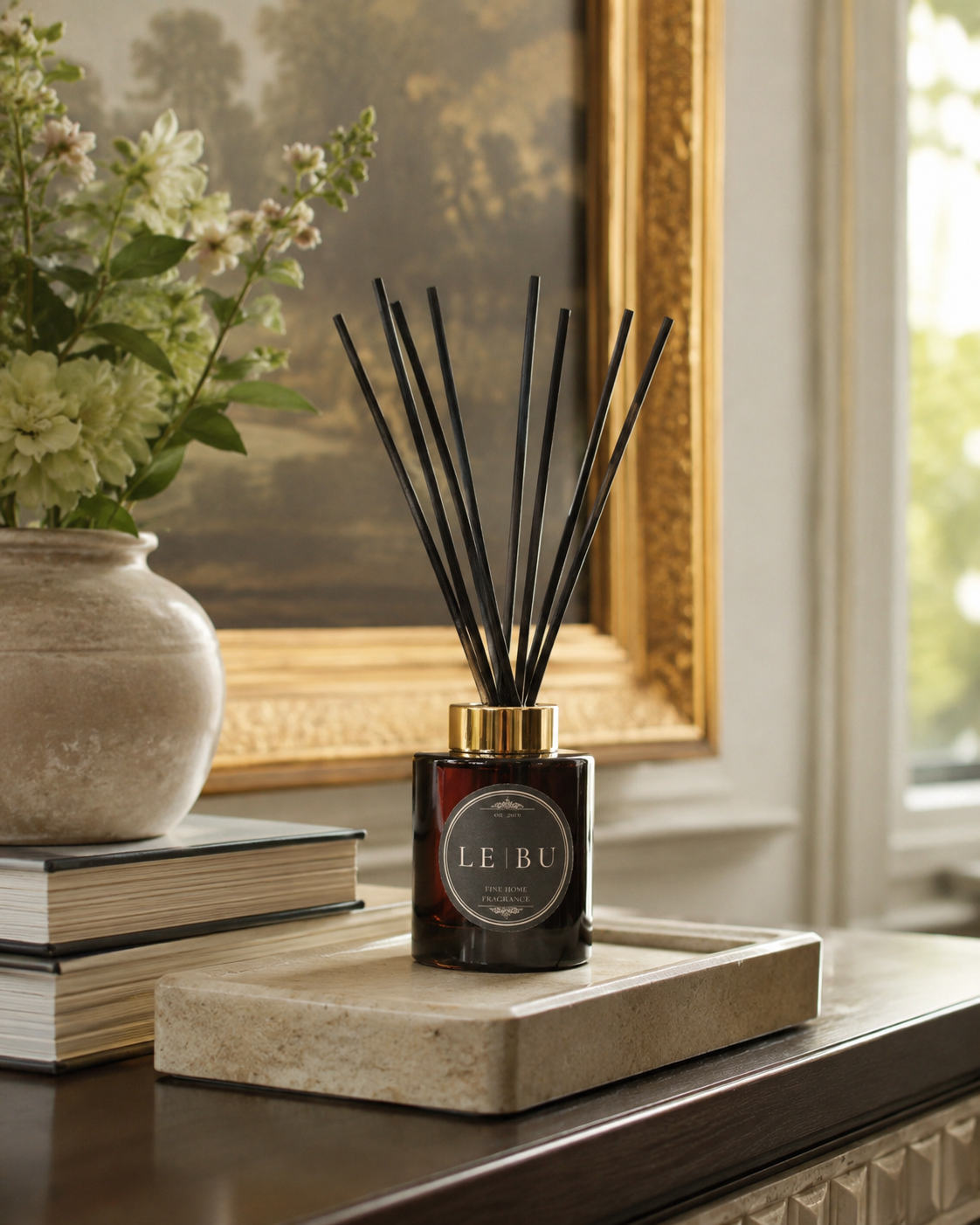 LE BU 100ml reed diffuser in dark green glass styled with folded towels and stone bathroom accessories