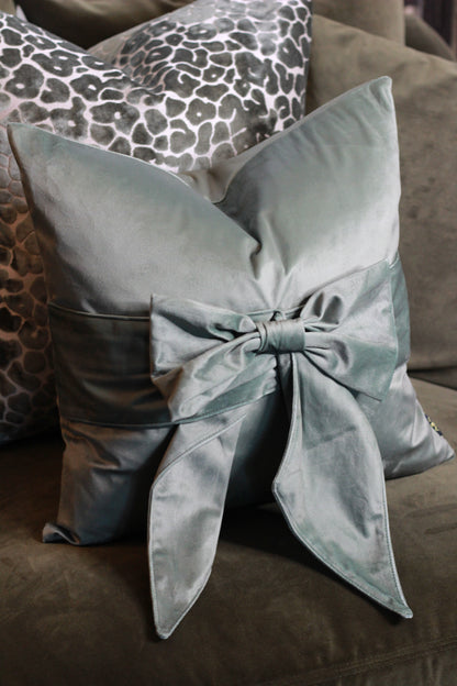 Sage Green Bow Velvet Cushion styled view – Leya Buster Interiors