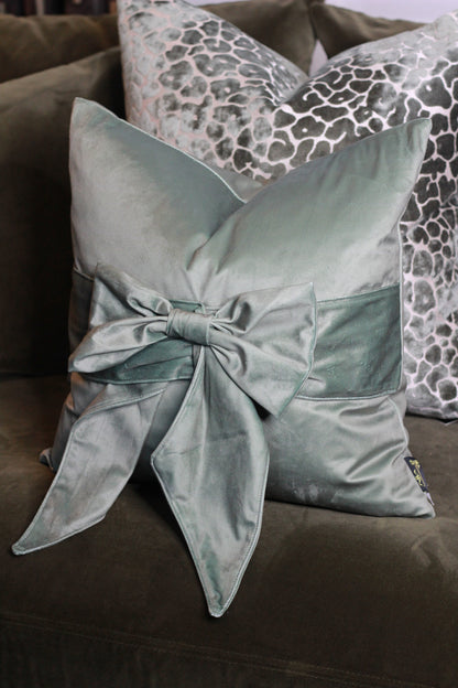 Sage Green Bow Velvet Cushion styled view – Leya Buster Interiors