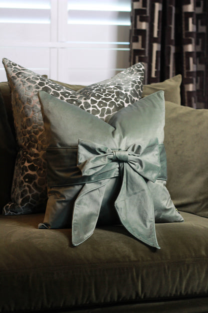 Sage Green Bow Velvet Cushion – decorative cushion at Leya Buster Interiors