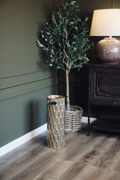 Detailed view of the textured gold finish on the decorative umbrella stand.