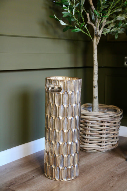 Gold umbrella holder shown from an alternative angle, highlighting its cylindrical shape.