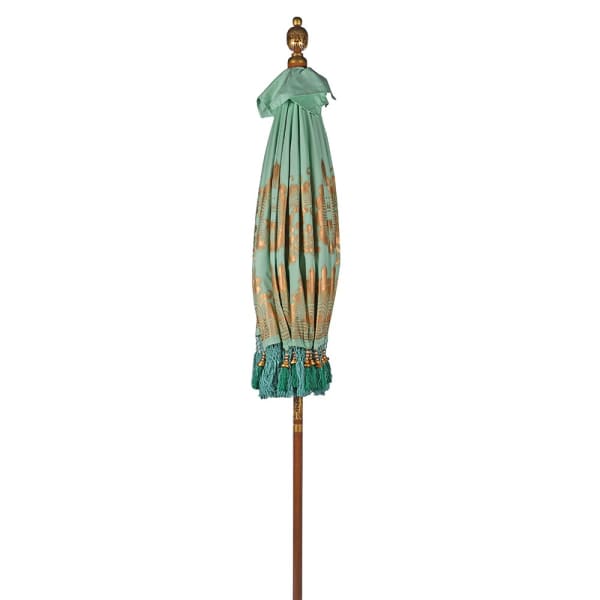 Close up of handmade Balinese-style mint garden parasol canopy with fringe and tassel trim