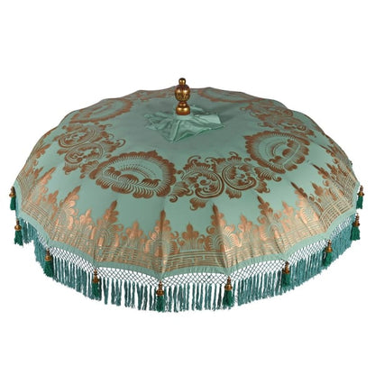 Close detail of handmade Balinese-style mint parasol fringe and green tassel edging