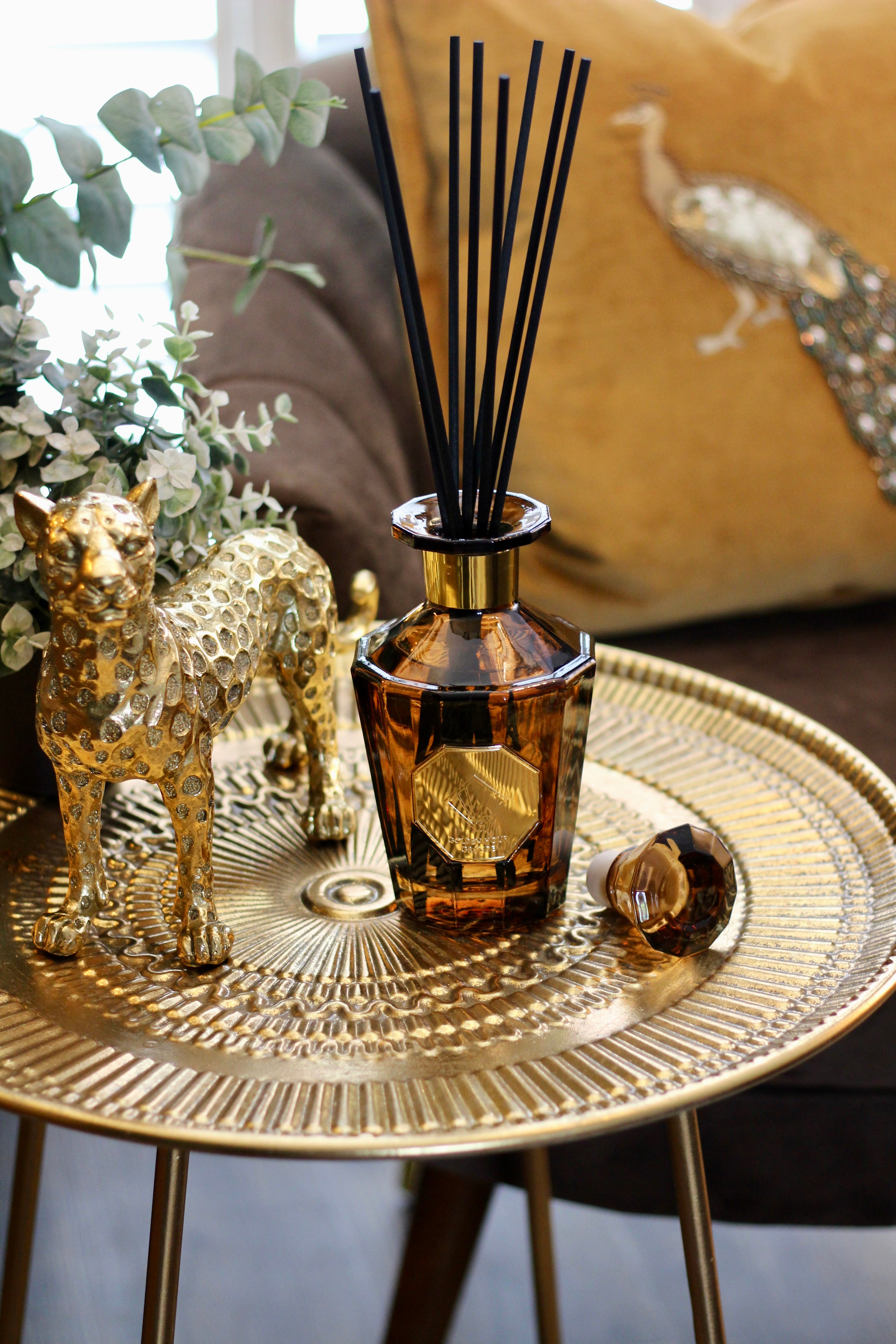 Scented reed diffusers in glass bottles from Leya Buster's home fragrance range